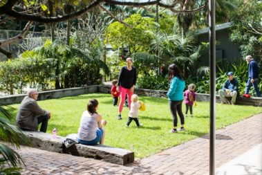 Kids playing on the Pinetrees lawn, Lord Howe Island
