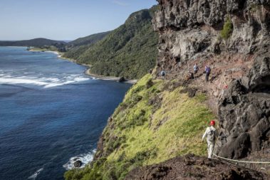Walkers on the dramatic Lower Road below Mt Lidgbird, Lord Howe Island